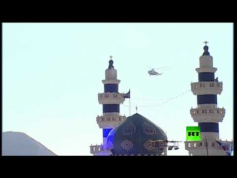 شاهد مشيعو سليماني ينتشرون على سفح جبل مقابل مقبرة الشهداء